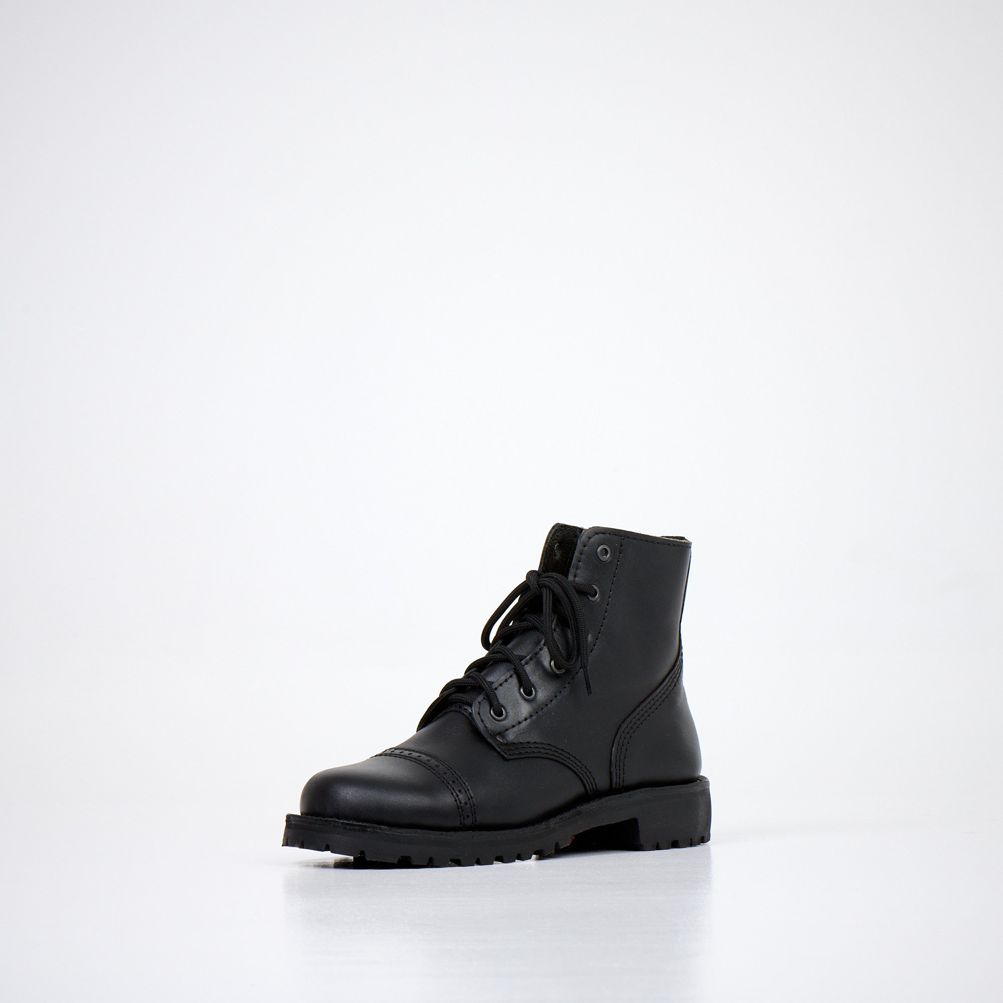 Bottines en cuir noir fait main, vue de profil sur fond studio