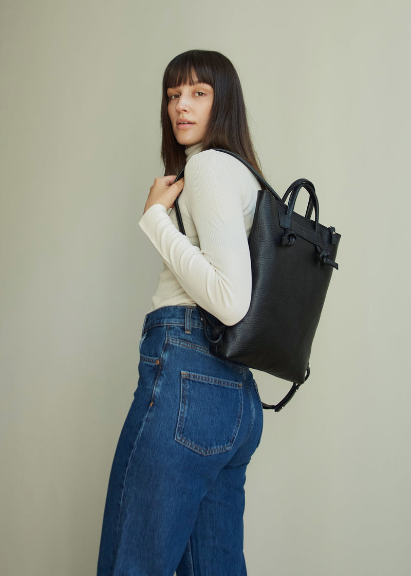 Sac à dos minimaliste en cuir marron, détail du rembourrage des épaules